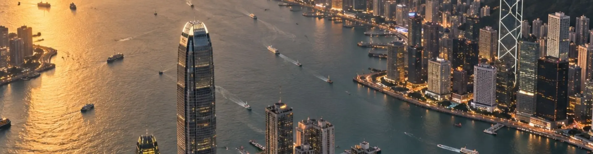 Aerial view of Hong Kong's Victoria Harbour skyline at golden hour, a premier private jet charter destination in Asia