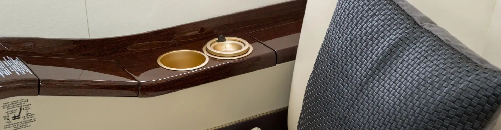Private jet cabin interior detail showing premium leather seat, highlighting onboard comfort unavailable in business class