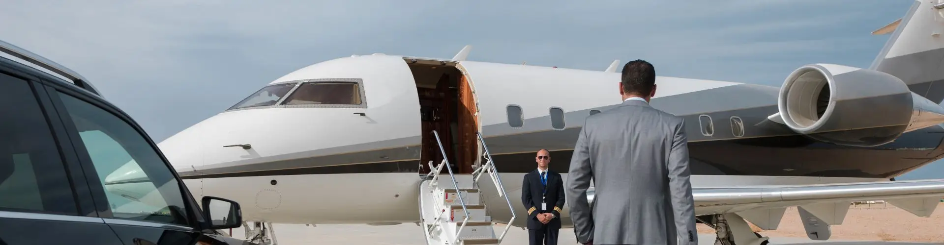 Private Jet for Mining in Indonesia: A Guide to Mining Charter Flights Business traveller walking toward a private jet, greeted by a crew member for a mining charter flight in Indonesia