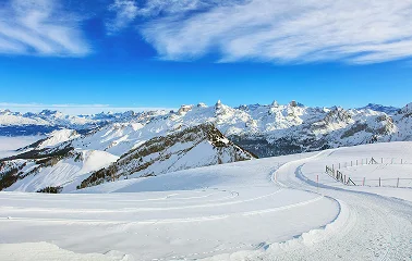 Pristine ski slopes wind through snow-covered Alpine mountains under brilliant blue skies at Lake Tahoe