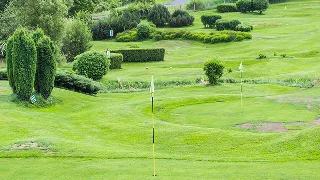 Pristine golf course with manicured greens, flag markers, and lush landscaping in Scottsdale