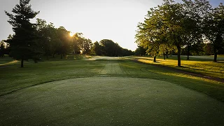 Pristine golf course fairway at sunrise with manicured greens and tree-lined holes in Palm Beach