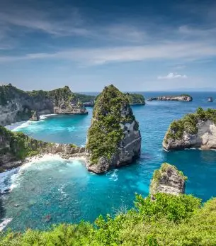 Dramatic limestone cliffs and turquoise lagoons showcase Bali's pristine coastline for luxury travelers