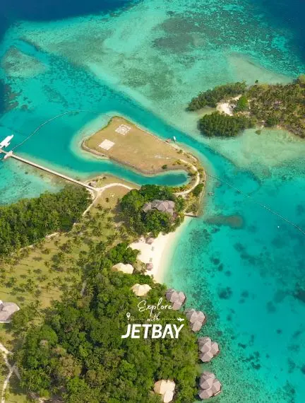 Aerial view of pristine tropical island airstrip surrounded by turquoise waters and lush greenery in Davao
