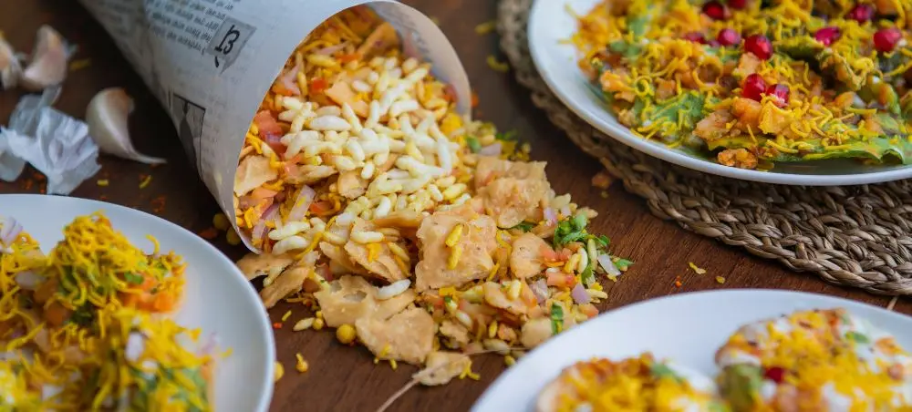 Authentic Delhi street food featuring spiced rice dishes and traditional Indian snacks served on rustic plates