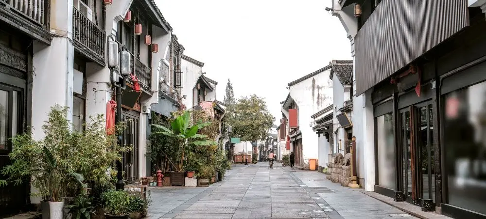 Traditional Chinese street in Hangzhou with historic architecture and stone walkway for luxury travelers