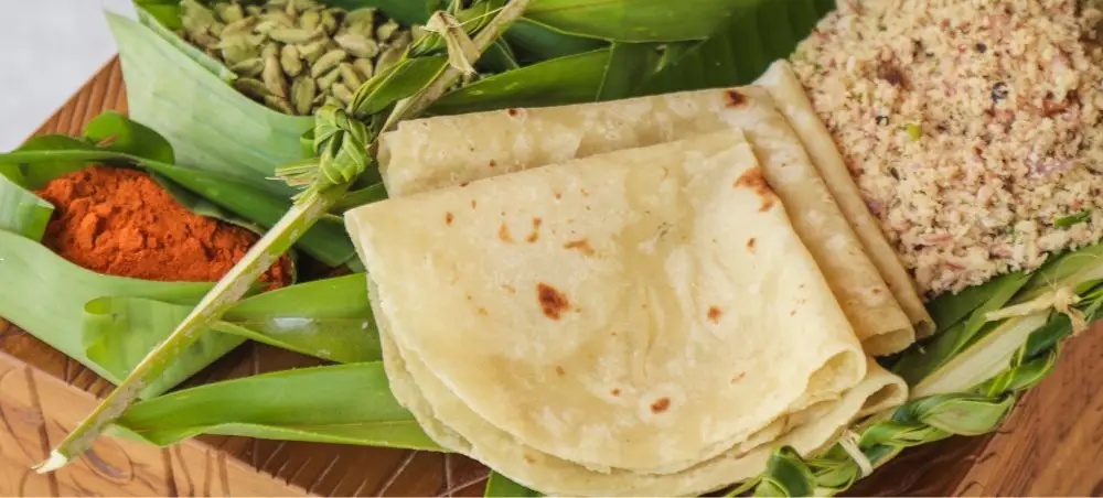 Traditional Maldivian flatbread and spices arranged on wooden platter showcasing authentic Male cuisine