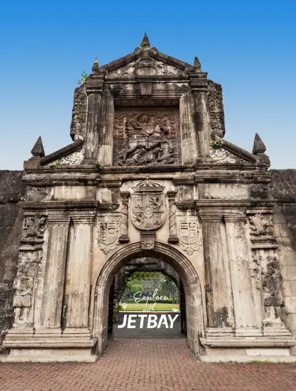 Historic Spanish colonial fortress gate in Manila showcasing ornate baroque architecture and carved stone details