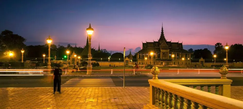 Royal Palace illuminated at twilight in Phnom Penh, showcasing Cambodia's architectural heritage