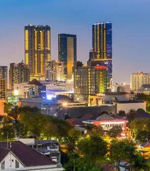 Surabaya skyline at twilight showcasing modern skyscrapers and urban development in Indonesia's second largest city