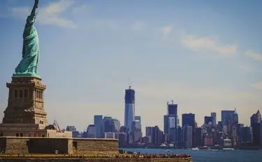 Private Jet Charter from Teterboro Airport (TEB) Statue of Liberty overlooking Manhattan skyline showcasing New York's iconic landmarks for private jet travelers