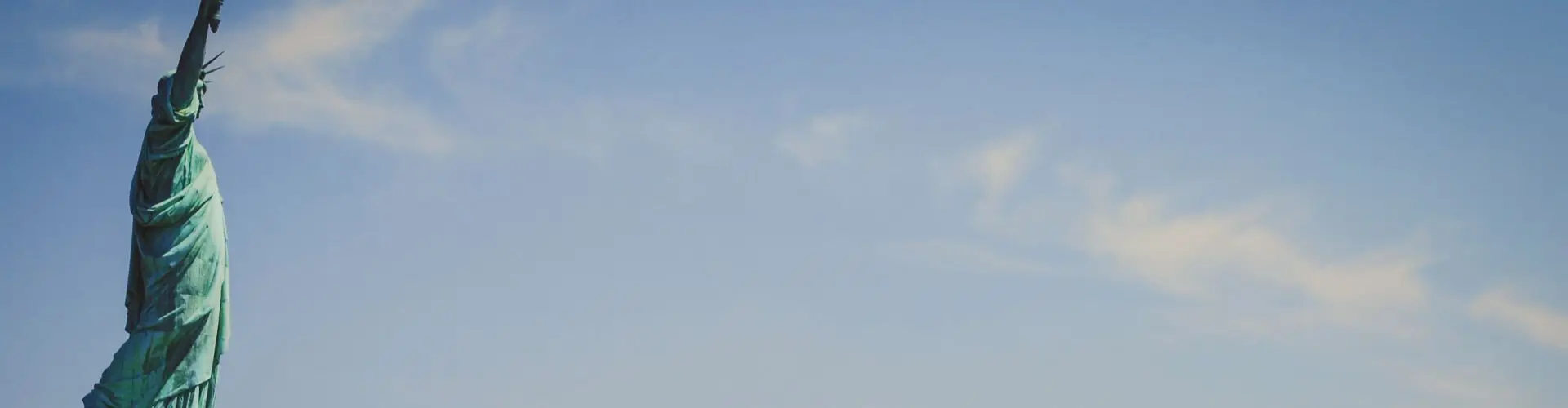 Private Jet Charter from Teterboro Airport (TEB) Statue of Liberty overlooking Manhattan skyline showcasing New York's iconic landmarks for private jet travelers