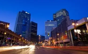 Private Jet Charter from Winnipeg Airport (CYWG) Winnipeg downtown skyline dusk illuminated skyscrapers light trails for private jet charter passengers