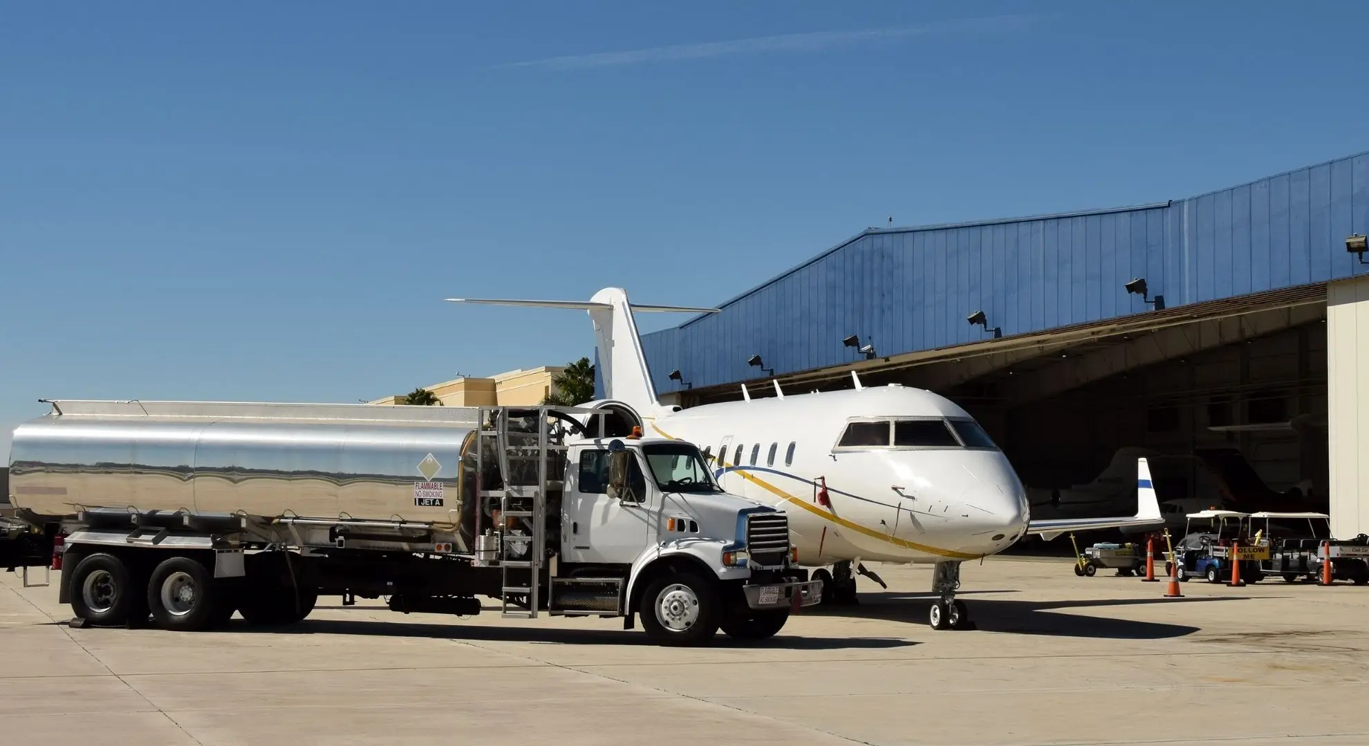 Private jet being refueled at airport hangar for sustainable aviation